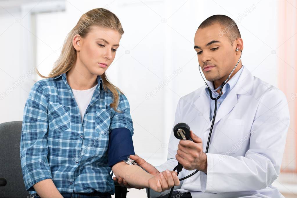 doctor measures the pressure to  patient 