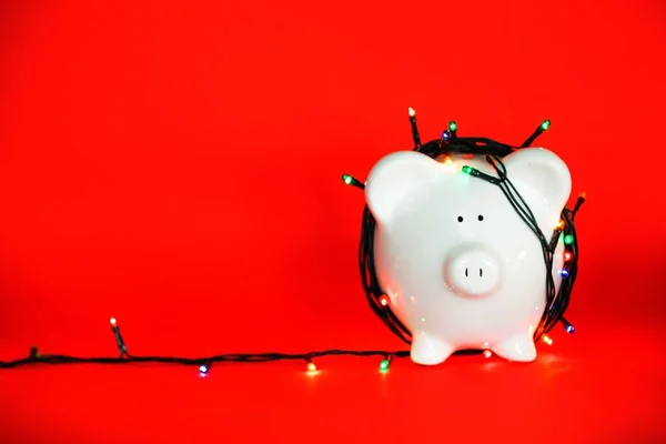 Ceramic piggy bank in the garland — Stock Photo, Image