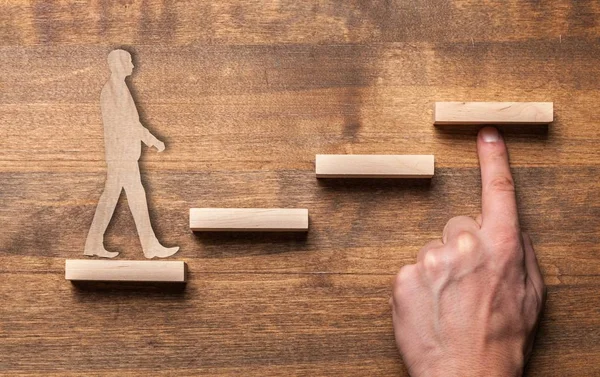 Wooden businessman climbing  block stairs — Stock Photo, Image