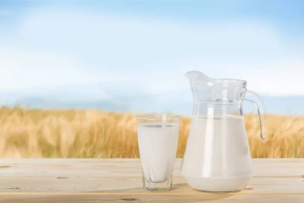 Glass of milk and  jar — Stock Photo, Image