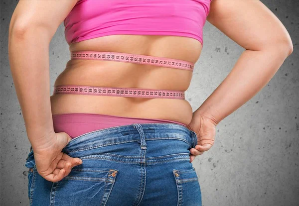 Fat woman measuring her stomach — Stock Photo, Image