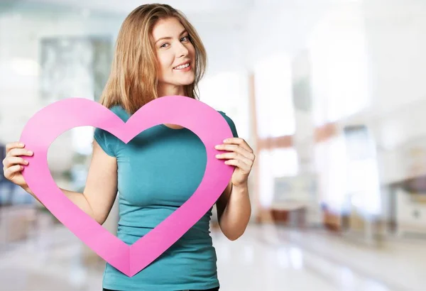 Girl holding pink paper heart — Stock Photo, Image