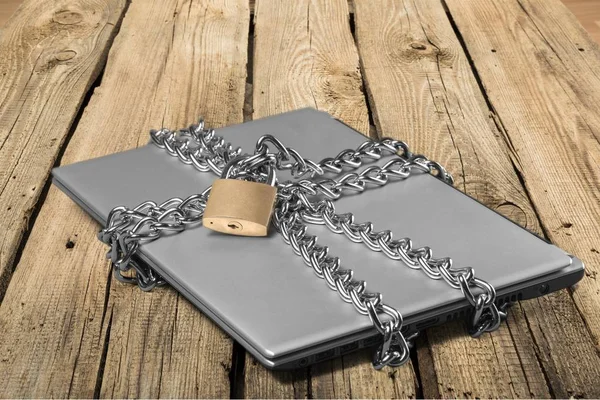 Laptop with chains and padlock — Stock Photo, Image