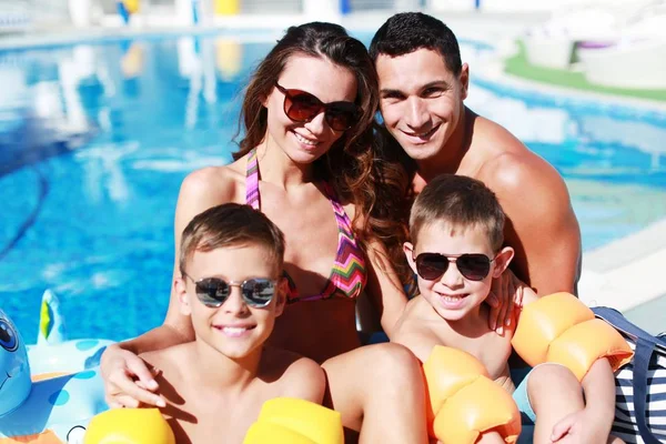 Ευτυχισμένη οικογένεια που παίζει στην πισίνα. — Φωτογραφία Αρχείου