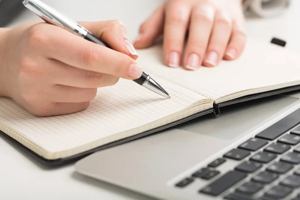 woman hand writing in notebook