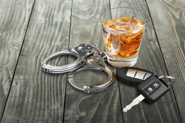 Whiskey met autosleutels en handboeien — Stockfoto