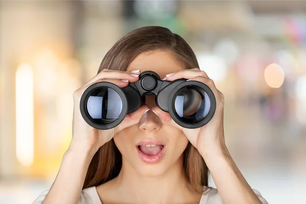 Young shocked woman with binoculars — Stock Photo, Image