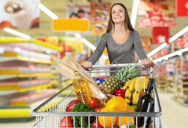 Woman with cart shopping Royalty Free Stock Images