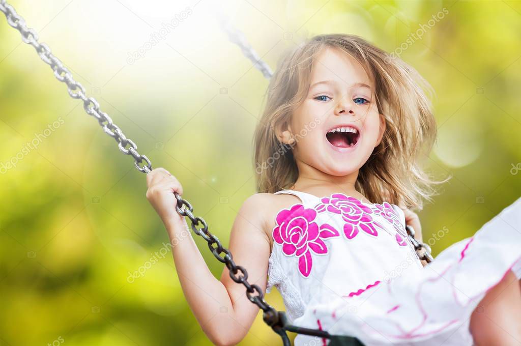 Little girl having fun on swing