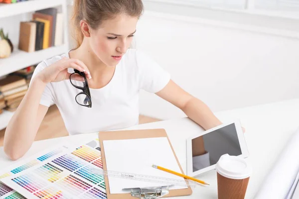 Young female designer with tablet — Stock Photo, Image