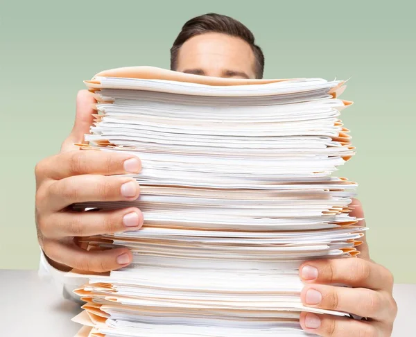 Young businessman with stack of papers — Stock Photo, Image