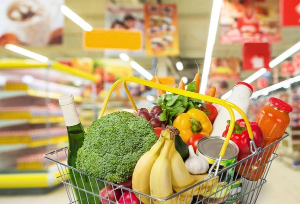 shopping basket with variety of grocery products