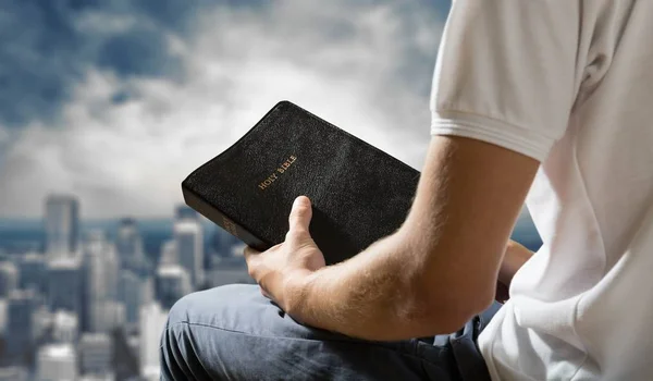 Hombre sosteniendo libro de la Biblia — Foto de Stock