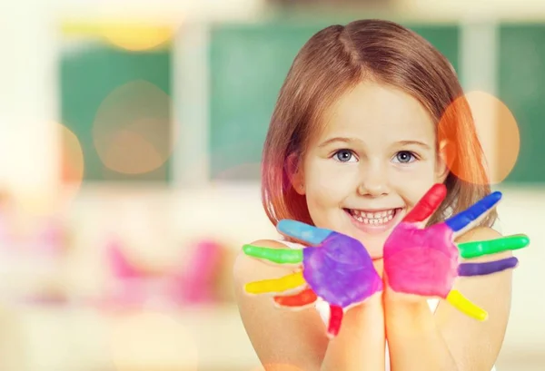 Little girl with colorful painted hands — Stock Photo, Image