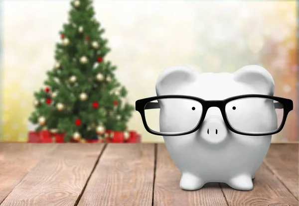 Blue piggy bank in glasses — Stock Photo, Image