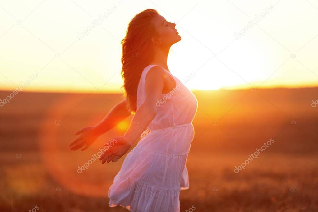 Woman under sunset light