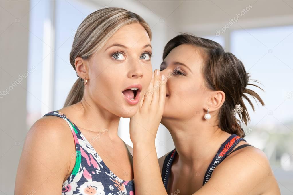 Woman revealing secret to friend 