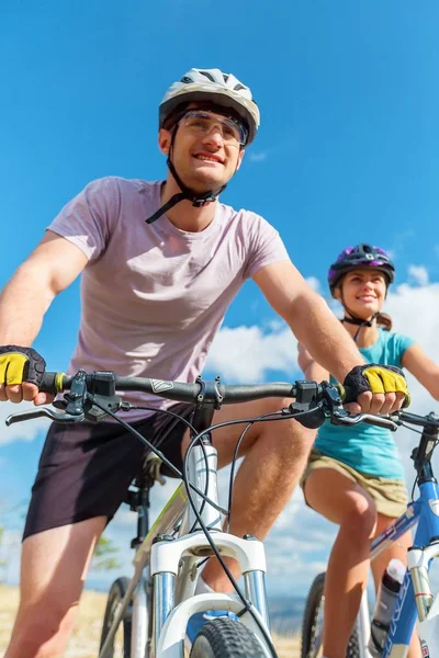 Happy couple riding bicycle outdoors — Stock Photo, Image