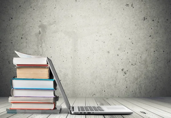 Stack of books with laptop - Stock Image - Everypixel