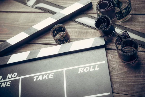 Film clipper and films on table — Stock Photo, Image