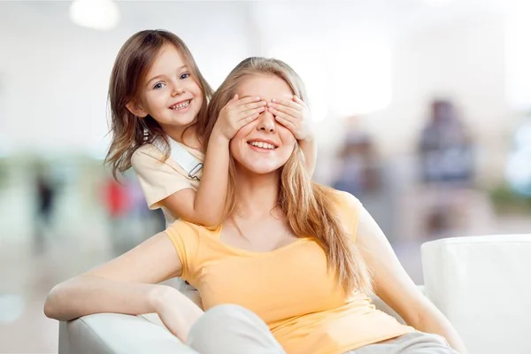 Girl covering her mother eyes