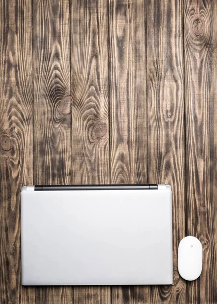 Silver laptop on wooden table — Stock Photo, Image