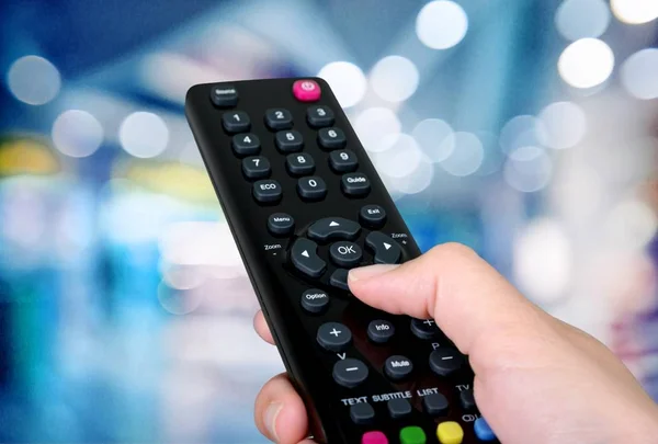Hand holding tv controller — Stock Photo, Image