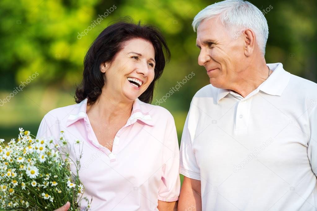 Senior couple smiling in park 