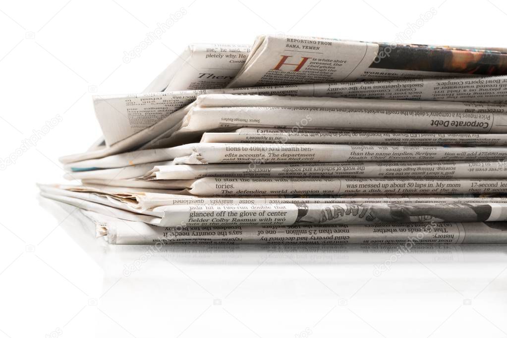 pile of printed newspapers
