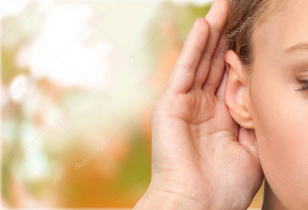 Girl listening with  hand on  ear