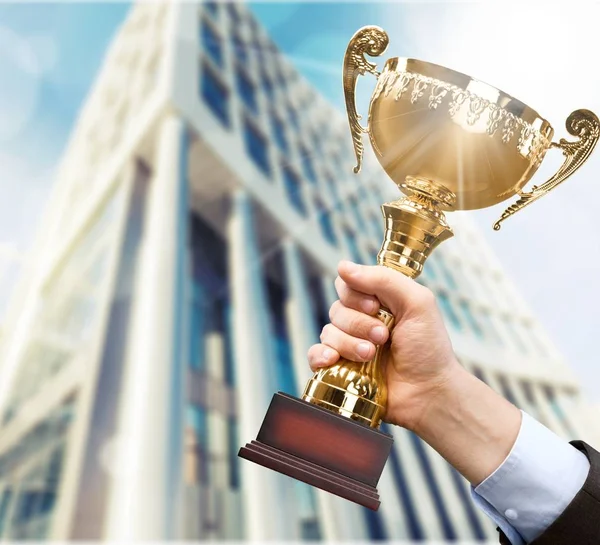 Hand holding golden Trophy — Stock Photo, Image