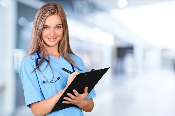 Doctor with stethoscope writting — Stock Photo, Image