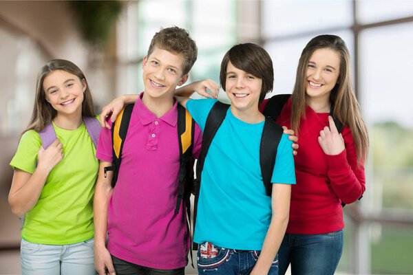 Friendly school children with backpacks