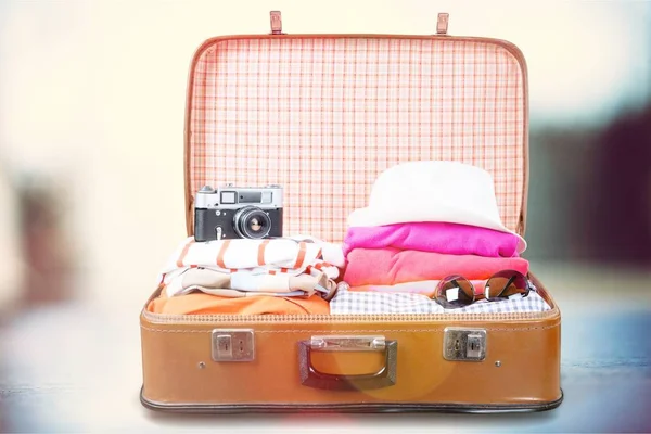 Retro-Gepäck mit bunten Klamotten — Stockfoto