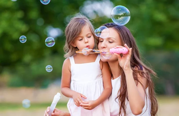 Женщина с девушкой и пузырьками — стоковое фото
