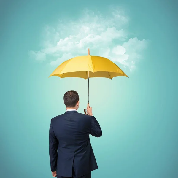 Business man holding umbrella — Stock Photo, Image