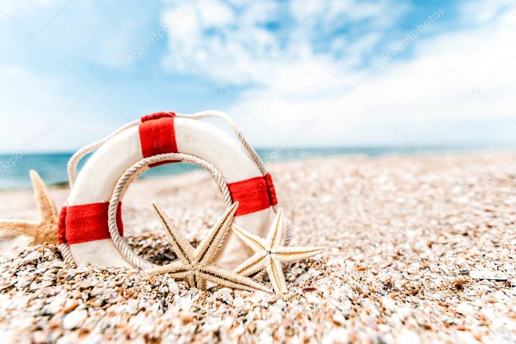 lifebuoy with starfish on beach