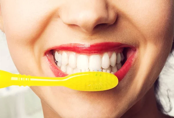 woman clean teeth with tooth brush