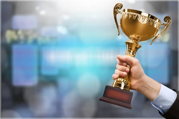 Hand holding golden Trophy — Stock Photo, Image