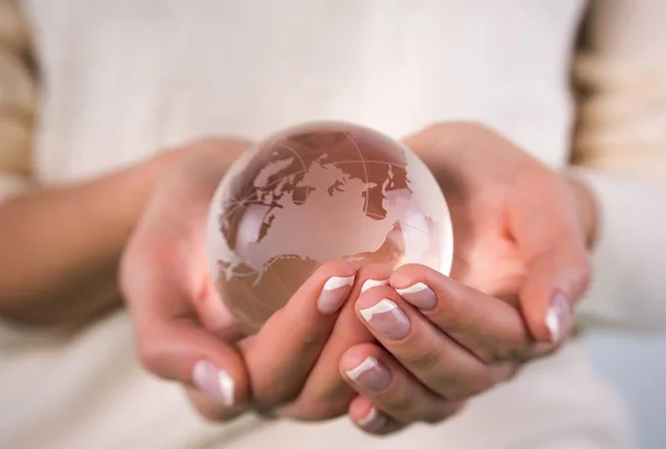 woman holding globe in hands