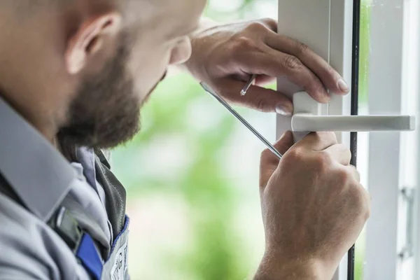 repairman fixing window frame