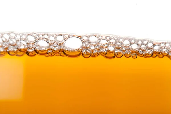 Yellow beer with foam and bubbles — Stock Photo, Image