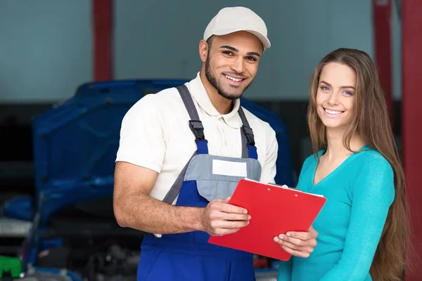 Hombre y mujer en taller de reparación de automóviles — Foto de Stock