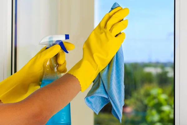 Gloved hands cleaning window — Stock Photo, Image