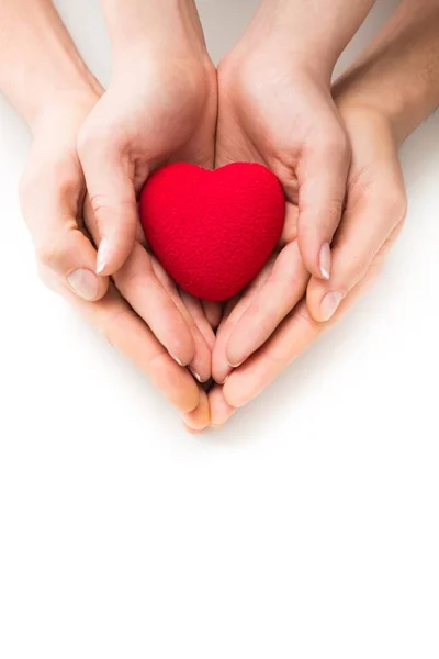 Male and female hands holding heart — Stock Photo, Image
