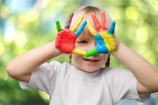 Little girl showing painted hands — Stock Photo, Image