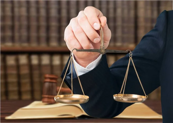 Hand holds scales symbol of justice — Stock Photo, Image