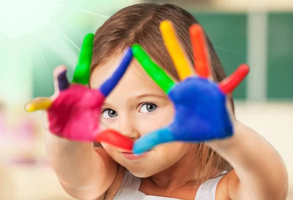 Little girl with colorful painted hands — Stock Photo, Image