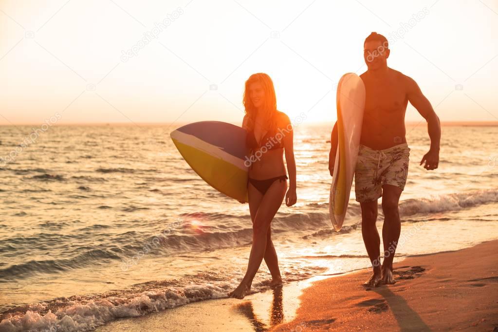 male and female surfers