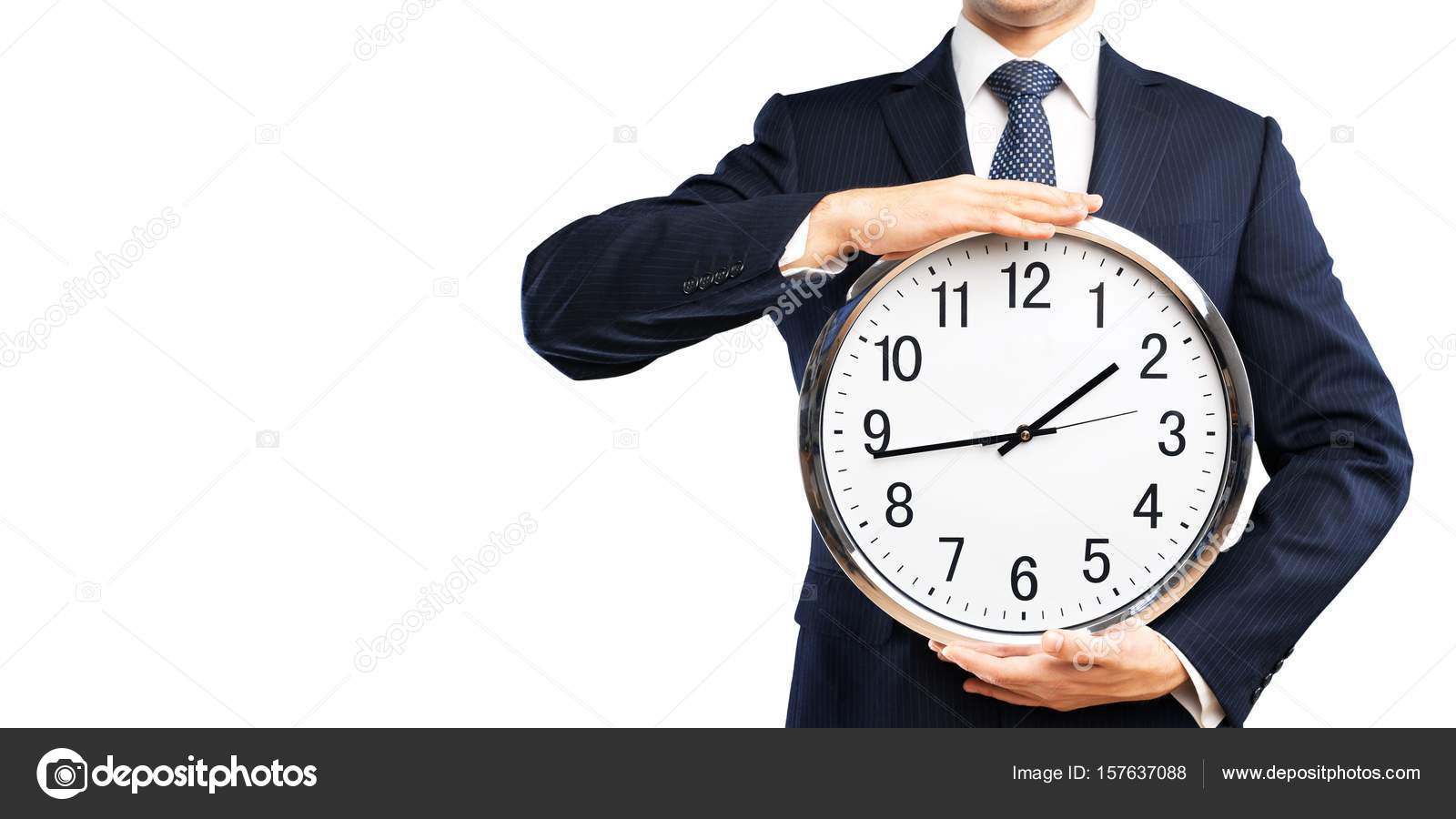 Businessman holding clock in hands Stock Photo by ©billiondigital 157637088